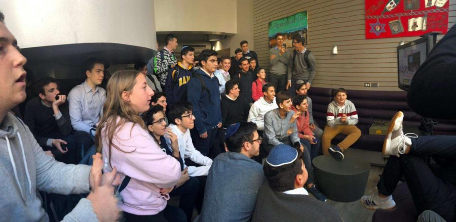 Students watch the Glouberman Tournament in the lounge.