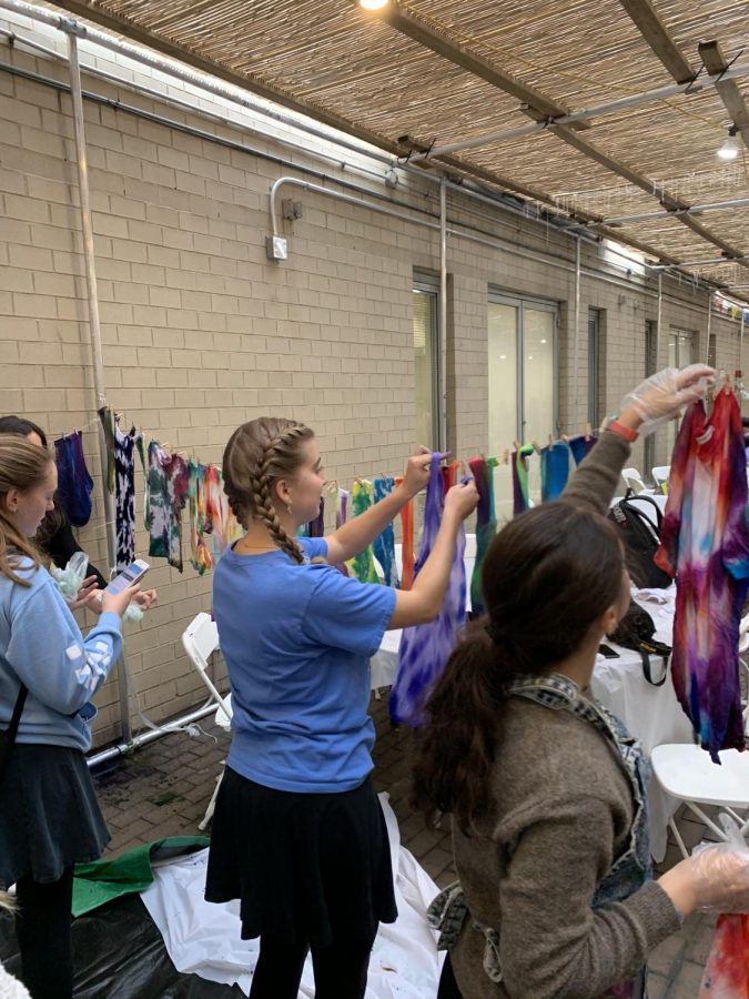 Students tie dying shirts in the Sukkah in 2019.